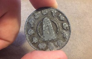 Sugarloaf grocer token from Curios and Conundrums by the Mysterious Package Company